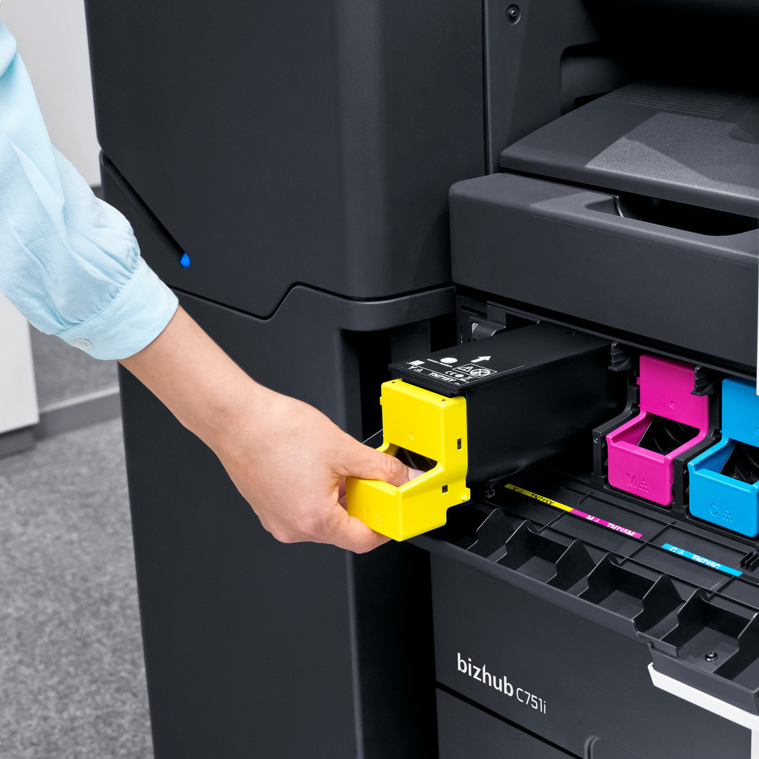 Technician replacing a toner cartridge in a bizhub multifunction printer